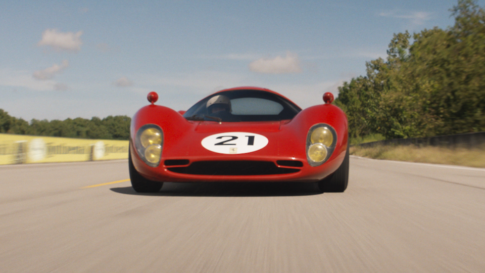 A replica Ferrari rockets fast and low around the track.